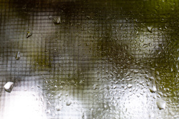 Rain drops, Water drops on mirror in bokeh green garden background, Close up & Macro shot, Selective focus, About Morning, Rainy day concept