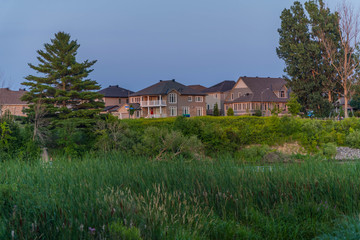 Houses between green fields in Ottawa, Canada
