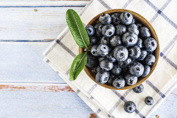 Fresh blueberries in wooden background.