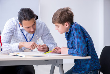 Male english teacher and boy in the classroom