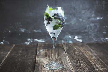 Billberry mojito cocktail in wine glass. Selective focus. Shallow depth of field.