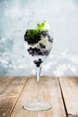 Billberry mojito cocktail in wine glass. Selective focus. Shallow depth of field.