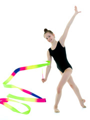 Girl gymnast performs exercises with tape.