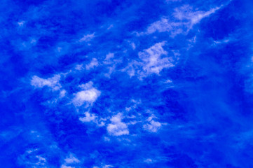 Fototapeta na wymiar Blue sky with feathery white clouds. Bottom view.