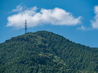 Power cable on mountain in Fukuoka prefecture, JAPAN. Power cable has been connected in the transmission steel towers.