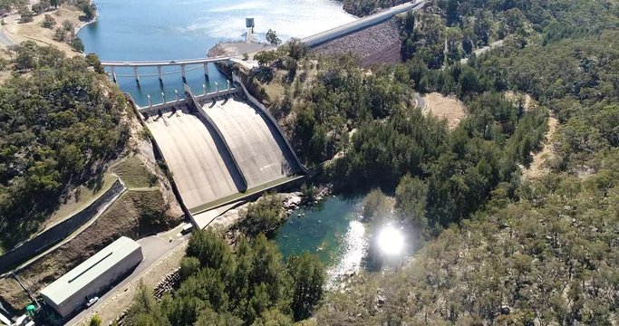Spill way off hydro energy dam on Coxs river and Lake Lyell in Blue Mountains of Australia &ndash; power generation plant between gum-tree covered hills.