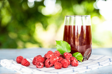 Fresh raspberries juice with bokeh background.