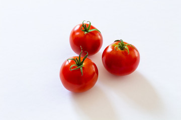small red cherry tomatoes on white background