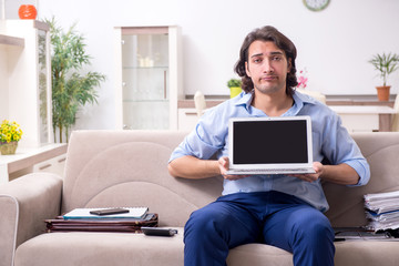 Young male employee working at home