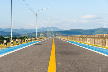 Way on the dam ridge heading towards the mountains.