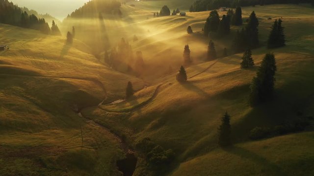 Aerial video of the sunrise in the Dolomites mountains. It was shot on the beautiful meadows of Seiser Alm plateau.