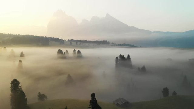 Aerial video of the sunrise in the Dolomites mountains. It was shot on the beautiful meadows of Seiser Alm plateau.