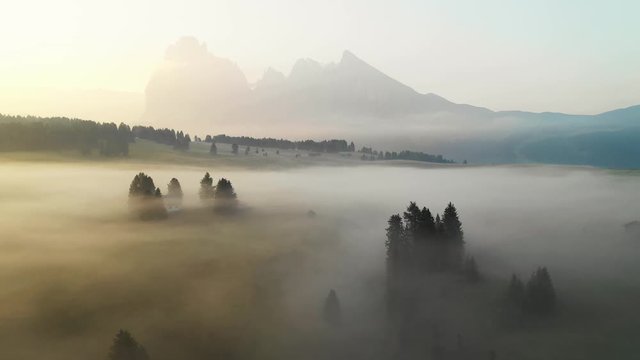 Aerial video of the sunrise in the Dolomites mountains. It was shot on the beautiful meadows of Seiser Alm plateau.