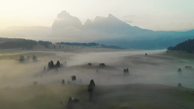 Aerial video of the sunrise in the Dolomites mountains. It was shot on the beautiful meadows of Seiser Alm plateau.