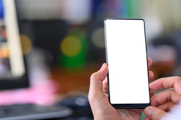 man using smartphone with blank screen for graphics display.
