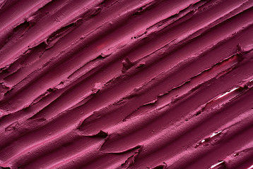 Smears and texture of  burgundy color lipstick or acrylic paint on a white background