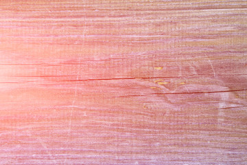 Old pine board with cracks, toned pink. Bright natural background.