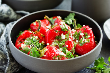 Baked bell peppers salad with herbs and garlic. Eastern dish.