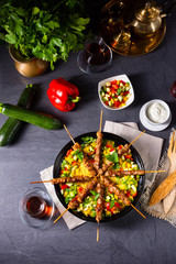 Lamb skewers with curry rice and different vegetables