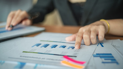 Young professional businesswoman planing the marketing strategy with charts and graphs