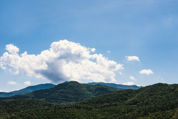 Obraz na płótnie Canvas Mountain landscape with lonely clouds on a blue sky