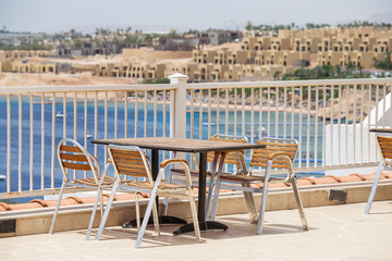 Fototapeta premium Table and chairs in beach cafe next to the red sea in Sharm el Sheikh, Egypt