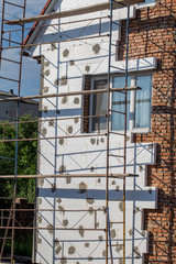 Scaffold on house, renovation. House for renovation with the scaffolding for workers on building