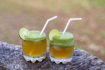 Summer two cold drinks with green tea and lime in nature on Bali, Indonesia. Close up