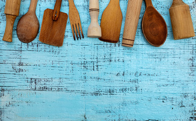 Vintage old kitchen utensils on a blue wooden background.