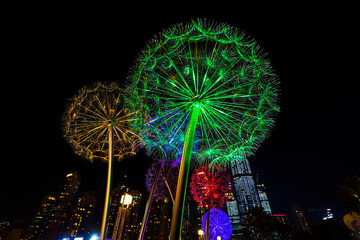Metal dandelion sculptures are part of the modern street art in Dubai. Street lamps in the central square.