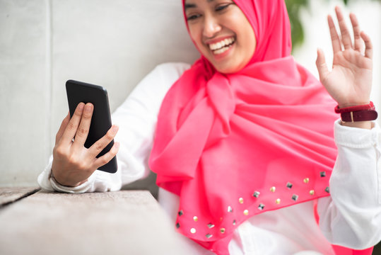 Young Muslim Woman Make Video Call Via Her Smartphone