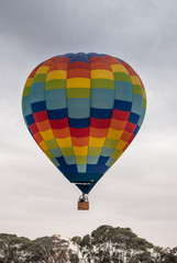 Obraz premium Colorful hot air balloon on blue sky background. Cold day