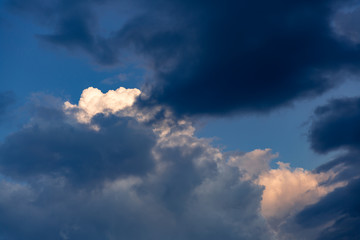 Dark blue pre-storm sky with the last glimmer of the sun.