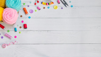 Sewing background. Accessories for needlework on old wooden background.