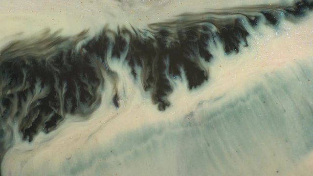 Liquid paint marbling texture. Black, gray, glitter white, silver colors mixing. Fluid gradient background