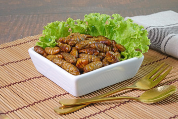 Edible insects : Deep fried crispy salted Silkworm pupae.  Entomophagy : Edible insects, other natural sources of nutrients. Famous street food in Thailand.