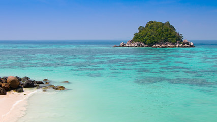 Beautiful landscape of tropical island with clear water, white sand beach and blue sky in Summer. Koh Lipe, Satun, Southern of Thailand. Travel and holiday vacation background concept.