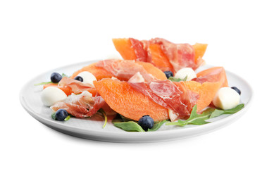 Fresh melon with prosciutto, mozzarella and arugula on white background