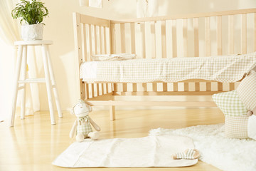 Shot of a crib in a modern white nursery room
