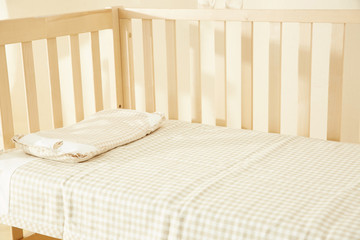 Fototapeta na wymiar Shot of a crib in a modern white nursery room