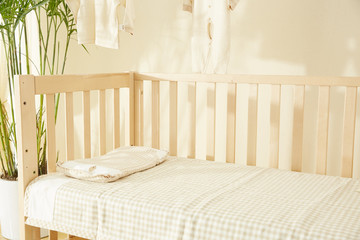Shot of a crib in a modern white nursery room