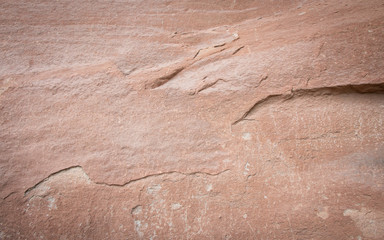 Close up of ancient red brown stone wall texture background with copy space.