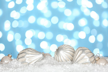 Obraz na płótnie Canvas Christmas decoration on snow against blue background