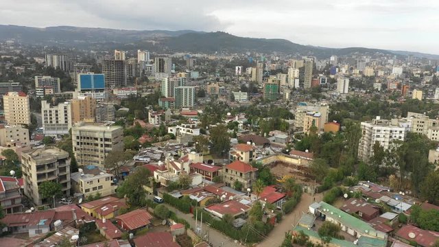 Drone flight over residential neighborhood in central district Addis Ababa, low-rise homes with corrugated sheets and development of apartment blocks, aerial footage Ethiopia Africa