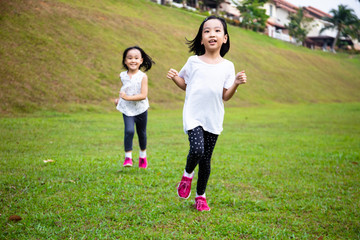 Asian Little Chinese Sisters running happily