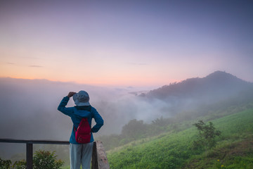 Fototapeta na wymiar The girl hiking on Phu-lum-daun near Mekong river border of Thailand and Laos, Loei province Thailand.