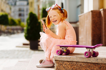 Positive delighted child laughing at funny joke