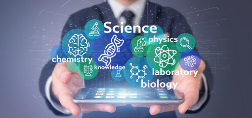 Businessman holding Science icons and title