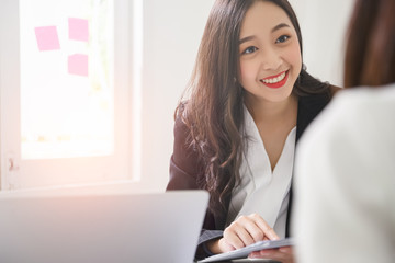 A young attractive asian woman is interviewing for a job. Her interviewers are diverse. Human...