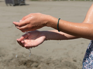 Female hands under running water